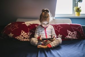 cute-girl-using-smartphone-bed